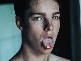 topless man with red tongue out